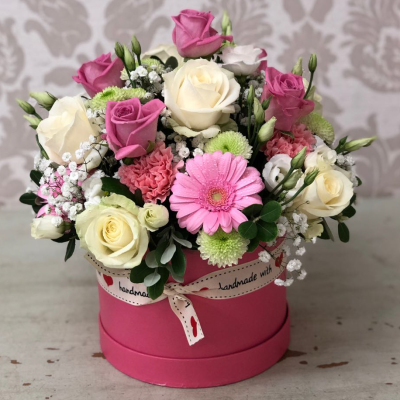 Pink Elegance - A delicate arrangement of pink and white roses and soft greenery in a pink round box, ideal for expressing love and appreciation.