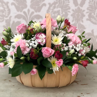 Country Garden Basket - A delightful basket arrangement filled with pink roses and white daisies, evoking the charm of a country garden.