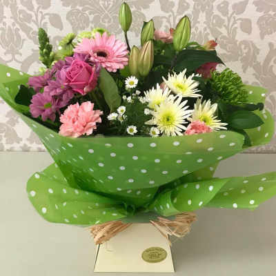 Colour Pop - A lively and colourful bouquet with a mix of pink, white, and green flowers, wrapped in paper.