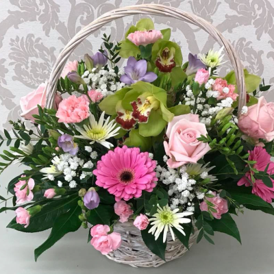 Orchid Basket Arrangement - A charming basket arrangement featuring pink roses, green orchids, and white accents, perfect for gifting on special occasions.