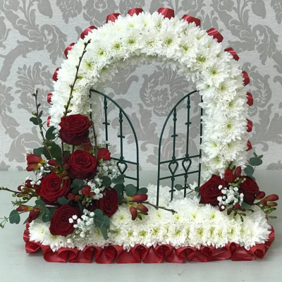 Gates of Heaven Funeral Tribute - A unique funeral tribute designed with a gate symbol, adorned with red roses and white chrysanthemums, representing the opening of heaven's gates.